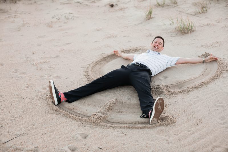 A man making angels in the sand